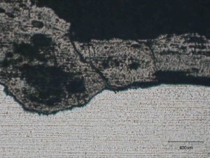 Section through pitting/grooving